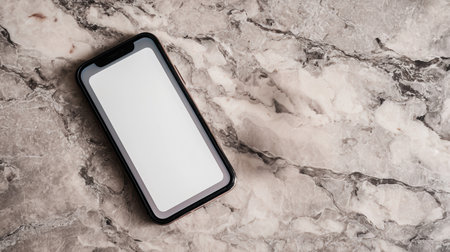 Smartphone mockup featuring a white blank screen on a marble countertop, enhanced by balanced studio lighting, perfect for showcasing digital designs and creative conceptsの素材