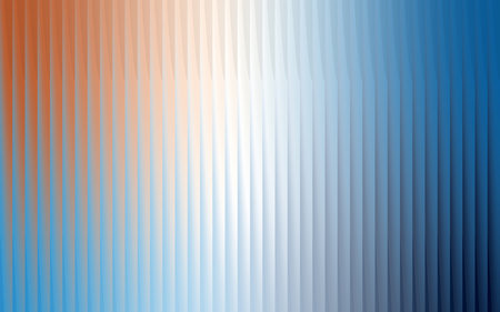 Abstract vertical stripes of warm orange and cool blue blend into a soft gradient of light and colorの写真素材