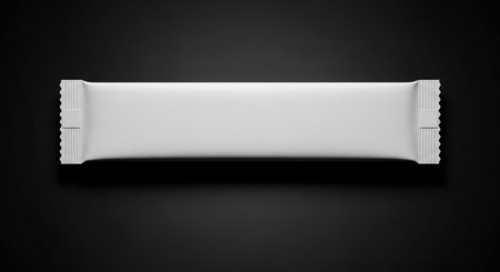 A blank white candy bar wrapper mockup is displayed on a black background in a top view. This studio shot is perfect for showcasing product packaging design.の素材