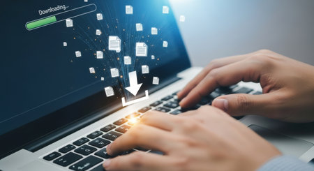 A man is downloading a file from the internet using his laptop. He is transferring data to the cloud. The download is in progress and the speed is fast and efficient.の素材
