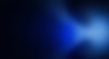 An abstract dark blue background with a soft, blurred light effect. The image creates a modern and atmospheric feel, perfect for various design projects.の素材