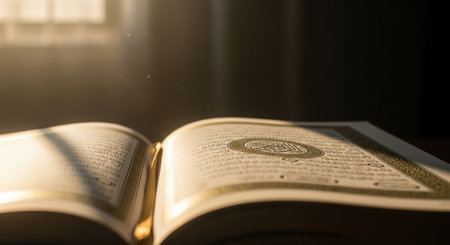 A close-up shot of an open Quran book with light shining through the window. It is a holy book for Muslims and is used for prayer and worship during Ramadan.の素材