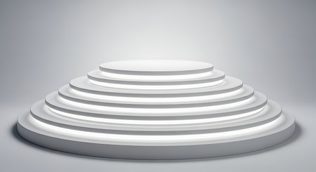 A minimalist white tiered circular platform or stage with subtle spotlight illumination on a neutral backgroundの素材