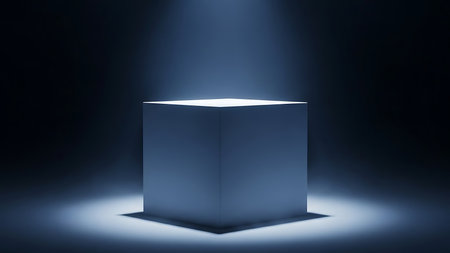 Illuminated pedestal in a dark room with a spotlight creating a dramatic atmospheric effectの素材
