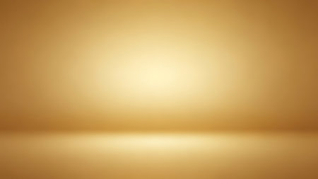 Warm golden studio background with soft light creating a subtle gradient for product placementの素材