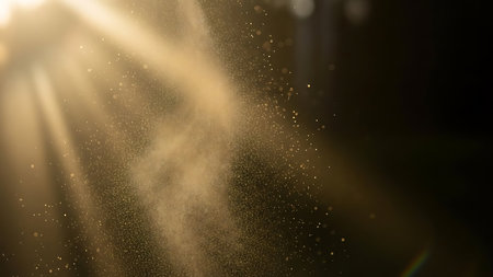 Golden sunbeams illuminate a stream of sparkling dust particles in a dark atmospheric forest settingの素材