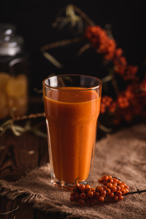 Sea buckthorn fresh autumn beverage in a glassの写真素材