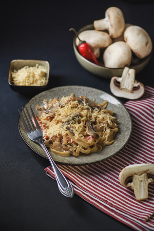 fettuccine pasta with mushrooms dark background italian dinner rusticの写真素材