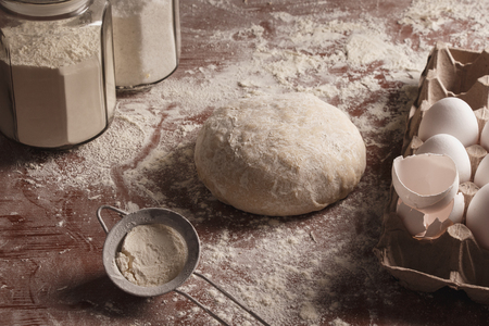 dough on a dark background with ingredients flour bread bakeryの写真素材