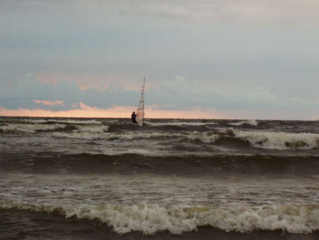 Lonely surfer at night on Gulf of Rigaの写真素材