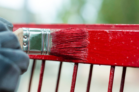 Painting a fence with a brushの写真素材