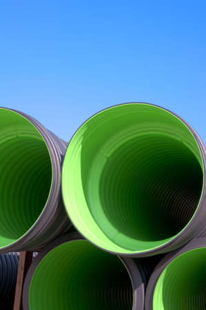Stack of green tubes on a construction siteの写真素材