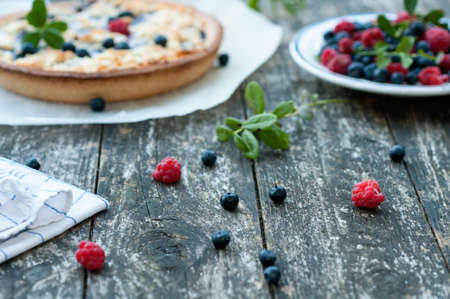 Fresh wild blueberries and raspberries and a blueberry cakeの写真素材