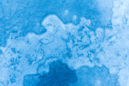 Structures in the ice of an frozen lake in winter. Usable as backgound or texture.