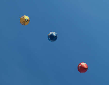 Colorful hot air balloons high in a bright blue skyの写真素材