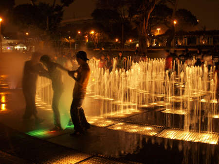 Playing in fountain at nightのeditorial素材
