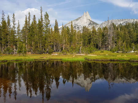 Mountain peak reflection on water surface in Yosemiteの写真素材