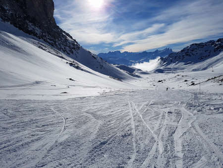 Skiing slope in alpine mountain resort