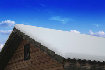 Wooden roof, drooping snow, winterの写真素材