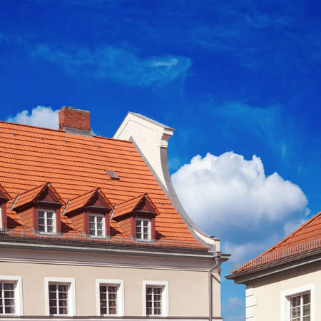  brick building, red roof, blue skyの写真素材
