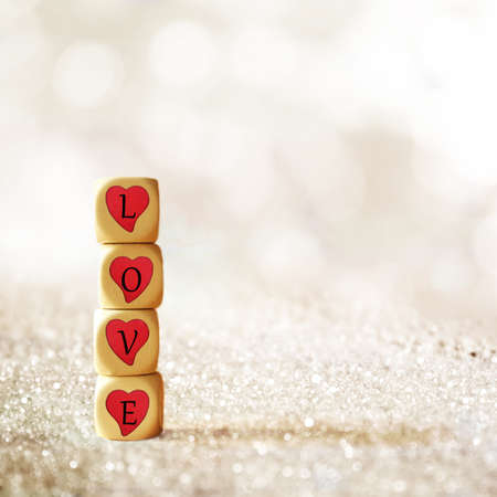 Wooden dice with the word loveの写真素材