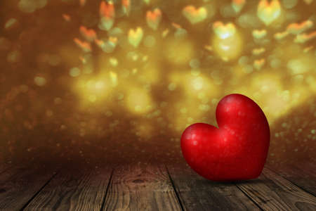 Heart on a wooden table against a bokeh backgroundの写真素材