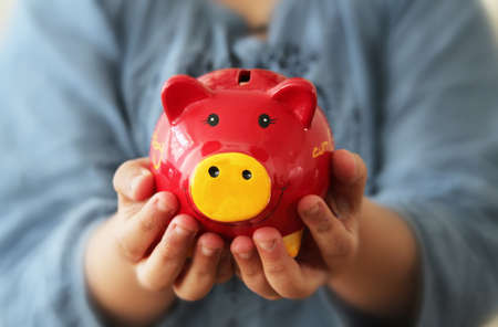 Young girl holding a piggy bankの写真素材