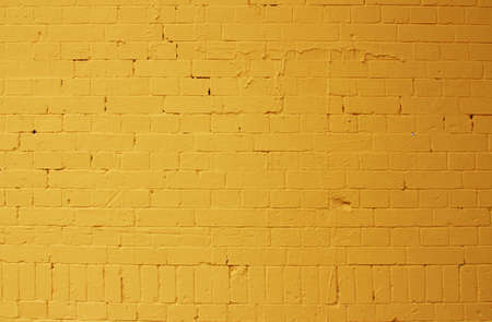 Background pattern texture made from a bright yellow brick wallの写真素材