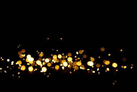 Blurred shimmering lights on a black background. Perfect bokeh backdropの写真素材