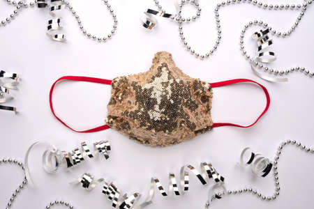 Beautiful festive golden party face mask. Safe selebration Christmas and New Year during Covid-19.