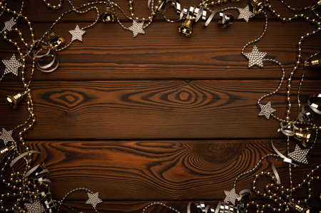 Festive christmas gold and siver frame on a dark cozy wooden background with a copy space for your text or imageの写真素材