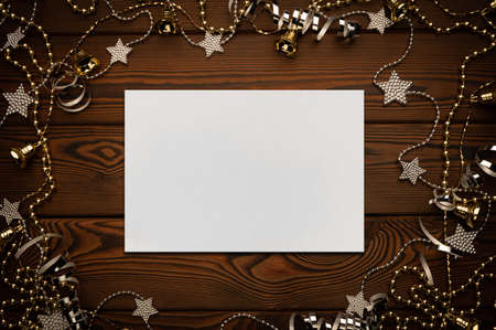 Festive christmas gold and siver frame on a dark cozy wooden background with a copy space for your text or imageの写真素材