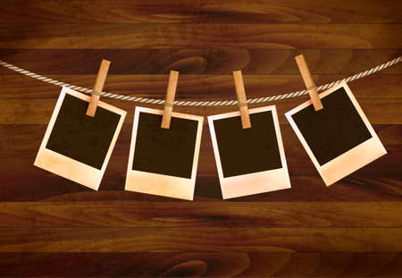 Retro photos hanging on a rope on dark wooden background. Vector.のイラスト素材