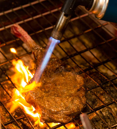 beef steak on the grill with flames.の写真素材