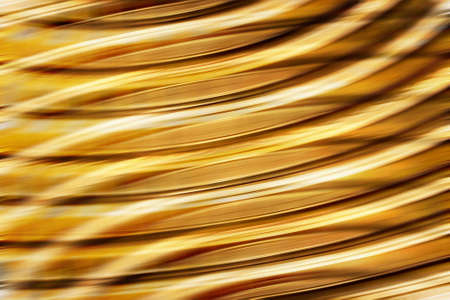 Background with golden lines in motion, light tones, could be useful as a texture.