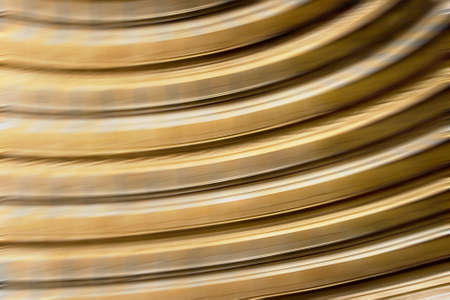 Background with golden lines in motion, light tones, could be useful as a texture.の写真素材