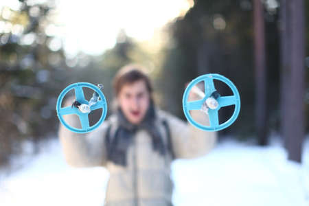Screaming skier with cross-country poles on sunny winter day in the forest (focus on poles)