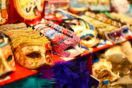 Beautiful group of colorful venetian masks with ornate decorations in Venice, Italyの写真素材