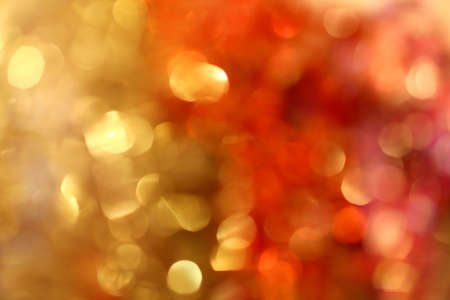 Golden with red Christmas lights at night. Beautiful blurred background.の写真素材