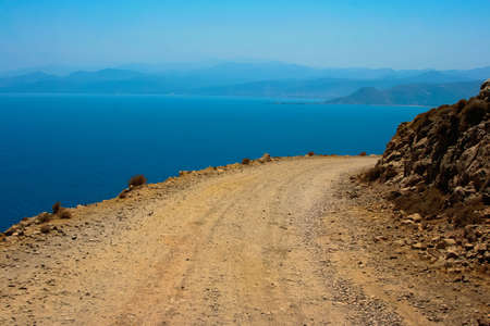 Mediterranean sea and gravel dangerous road, which leads to Gramvousa beach on island of Crete in Greeceの写真素材