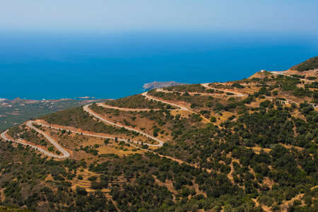 Mountain serpentine with many dangerous turns  Road near to Mediterranean sea at island of Crete, Greeceの写真素材