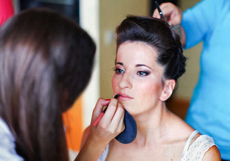 Bride's morning. Process of makeup artist preparing the bride before wedding