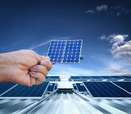 Photovoltaic power plant installation on the roof of a residential building on sunny day - Solar Energy concept image.の写真素材