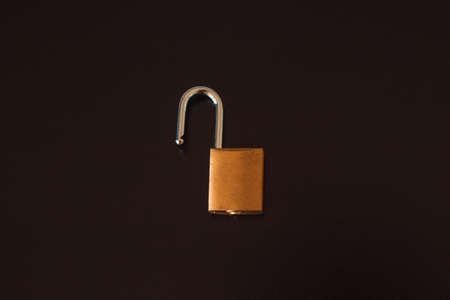 Padlock with key isolated on black background.の写真素材