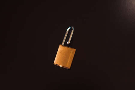 Padlock with key isolated on black background.の写真素材