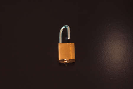 Padlock with key isolated on black background.の写真素材