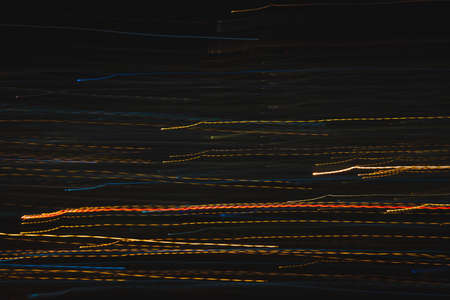 Lights trails in the black background. Color overlay light pattern.の写真素材