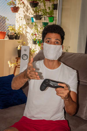 Man wearing protective mask against the coronavirus in house quarantine.の写真素材
