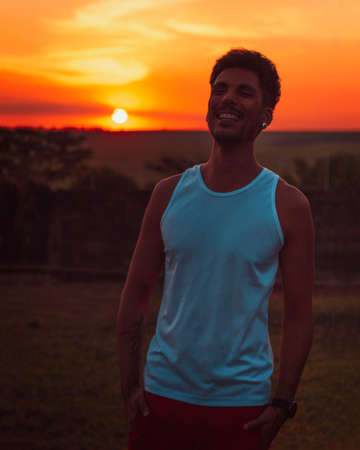 Adult black man at sunset blackground.の写真素材