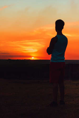 Adult black man at sunset blackground.の写真素材